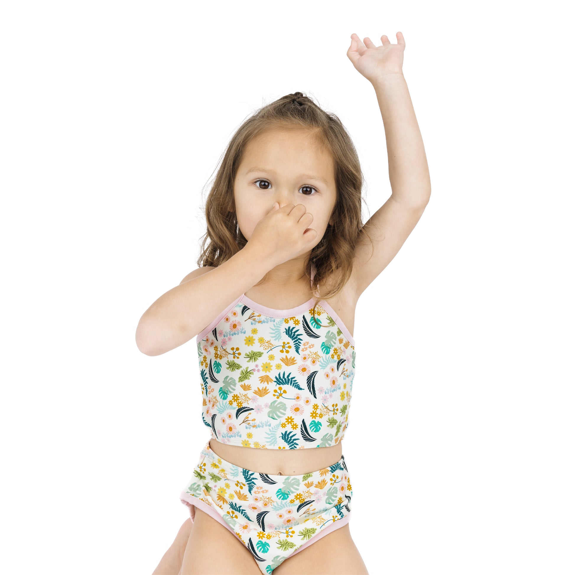 Young girl modeling the Tropical Blooms bikini, highlighting the secure, stay-put fit for active beach and pool play.