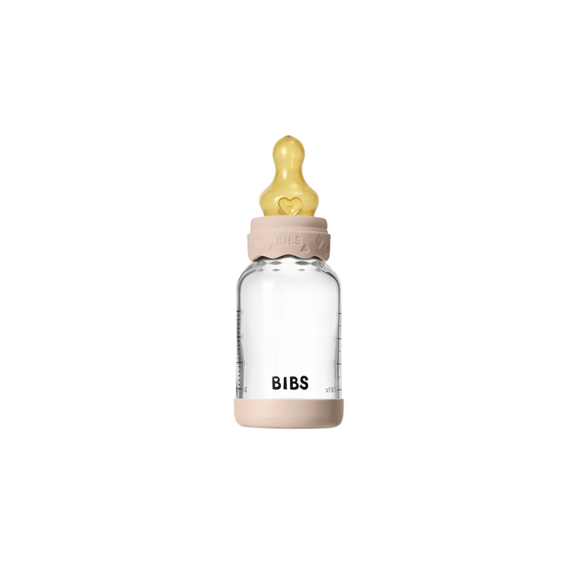 Clear baby bottle with pink cap and yellow nipple on a white background
