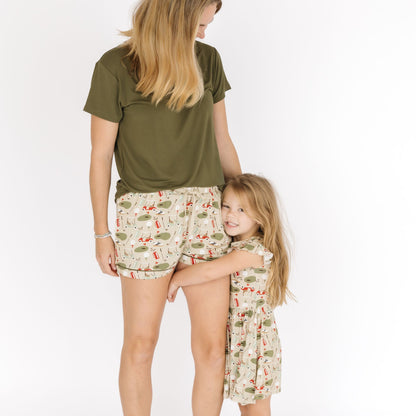 Woman and young girl wearing matching outfits with a white background