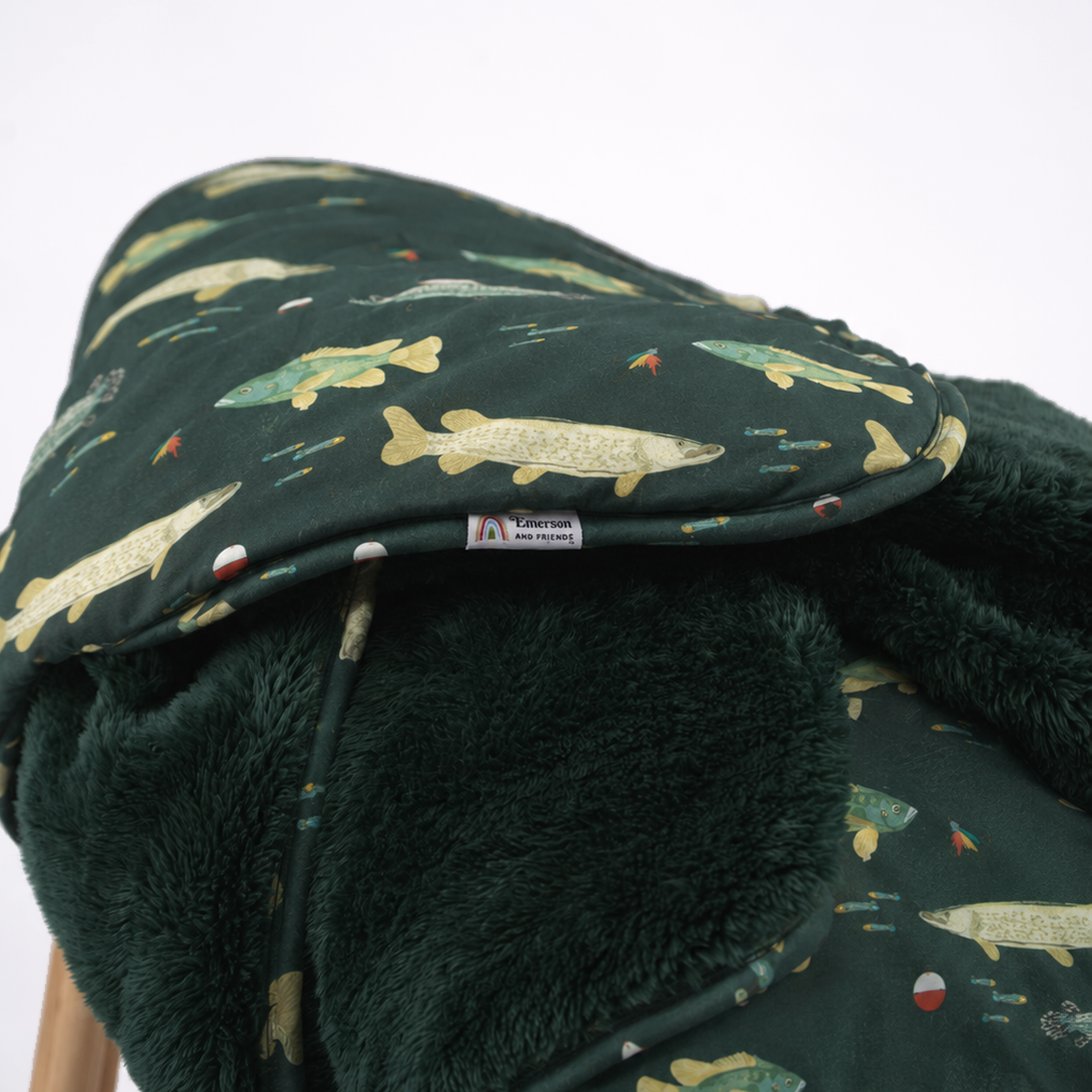 dark green blanket with fish print and dark green fleece lining.