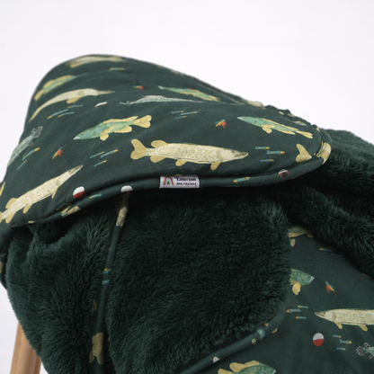 dark green blanket with fish print and dark green fleece lining.