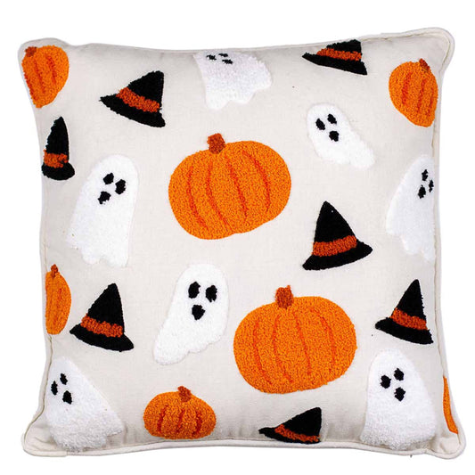 halloween themed pillow with a cream base color and embroidered pumpkins, ghosts, and witch hats on it
