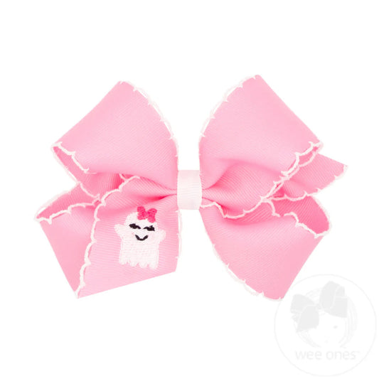 pink hair bow with white trim and an embroidered ghost on it