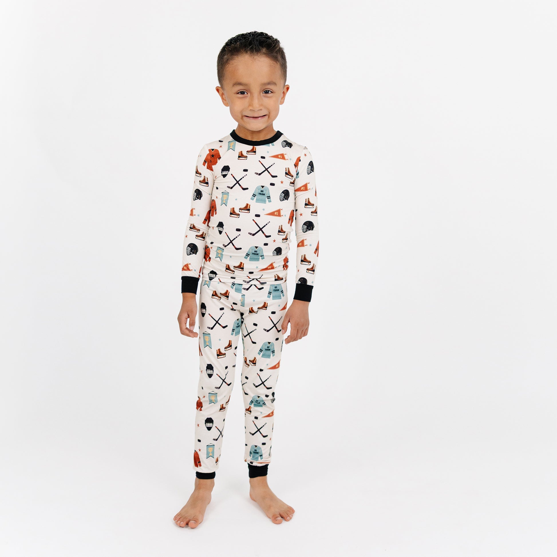Child wearing a patterned pajama set on a white background
