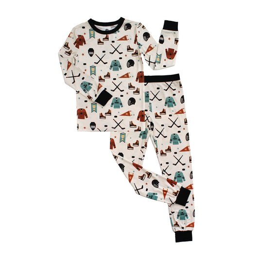 Children's pajama set with hockey-themed pattern on a white background