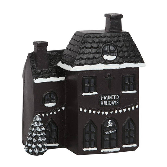 black ceramic haunted house that burns cone incense thats decorated for christmas and says haunted holidays