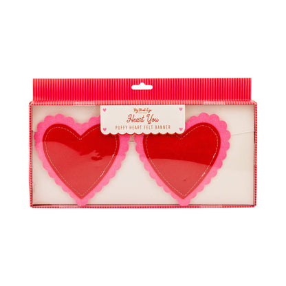 Red heart-shaped felt banner with pink edges in a packaging box on a white background