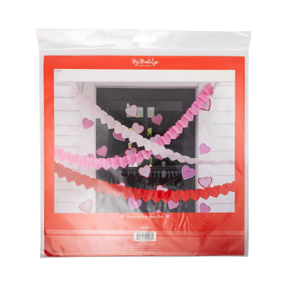 Packaged heart-shaped garland with pink and red colors on a white background