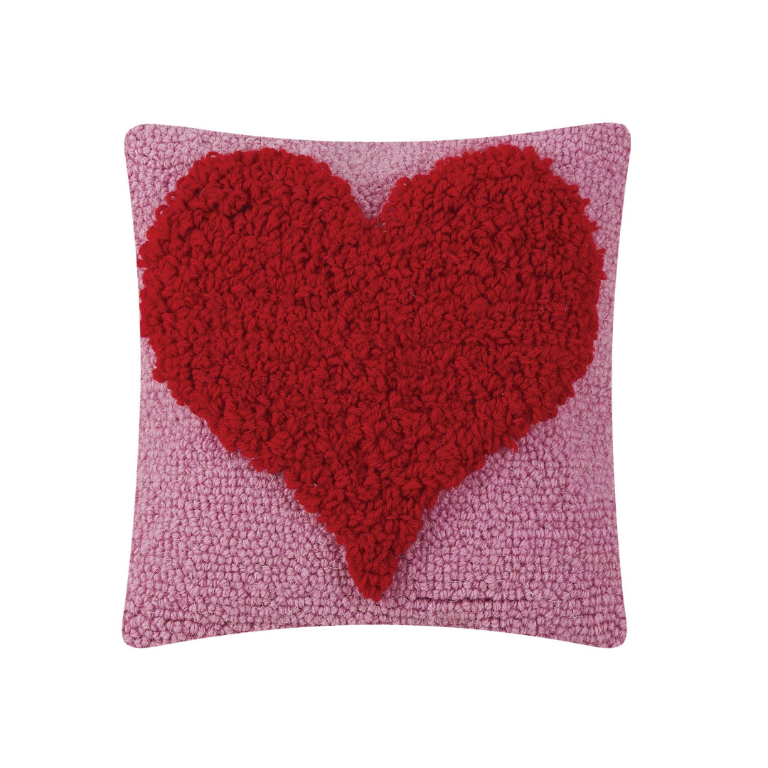 square pink hook pillow with a red heart on the front