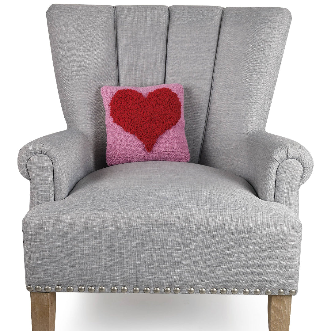 square pink hook pillow with a red heart on the front