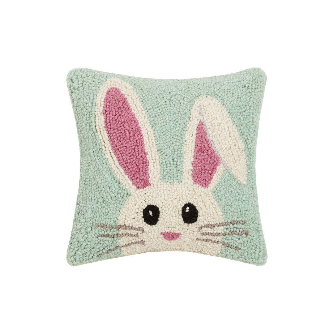 square hook throw pillow with a light blue background and a easter bunny head on the front