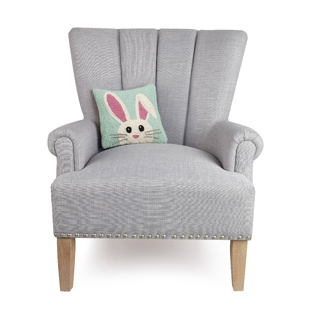 easter bunny throw pillow displayed on an overside chair