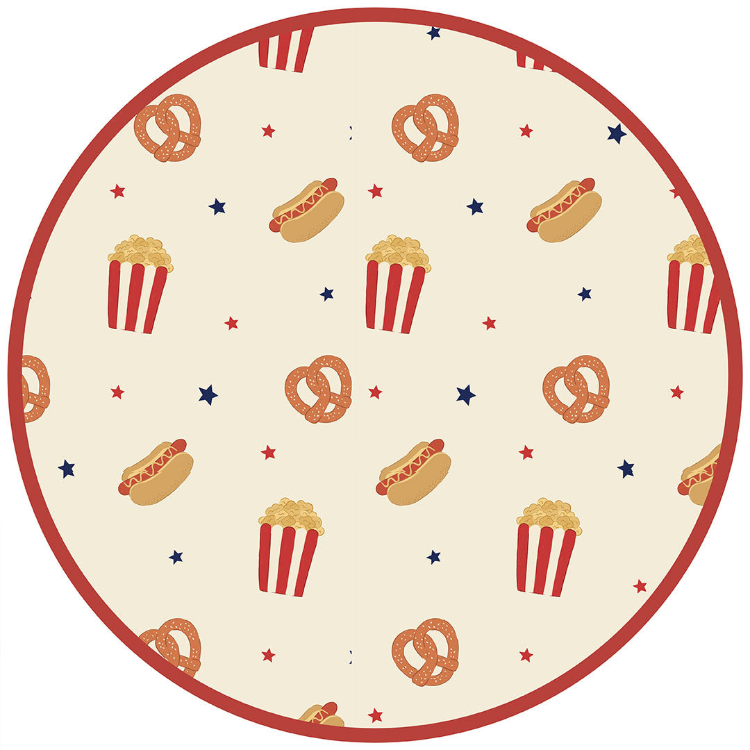 the "here for the snacks" print has a variation of pretzels, hotdogs, popcorn, and blue and red stars scattered around a beige background. 