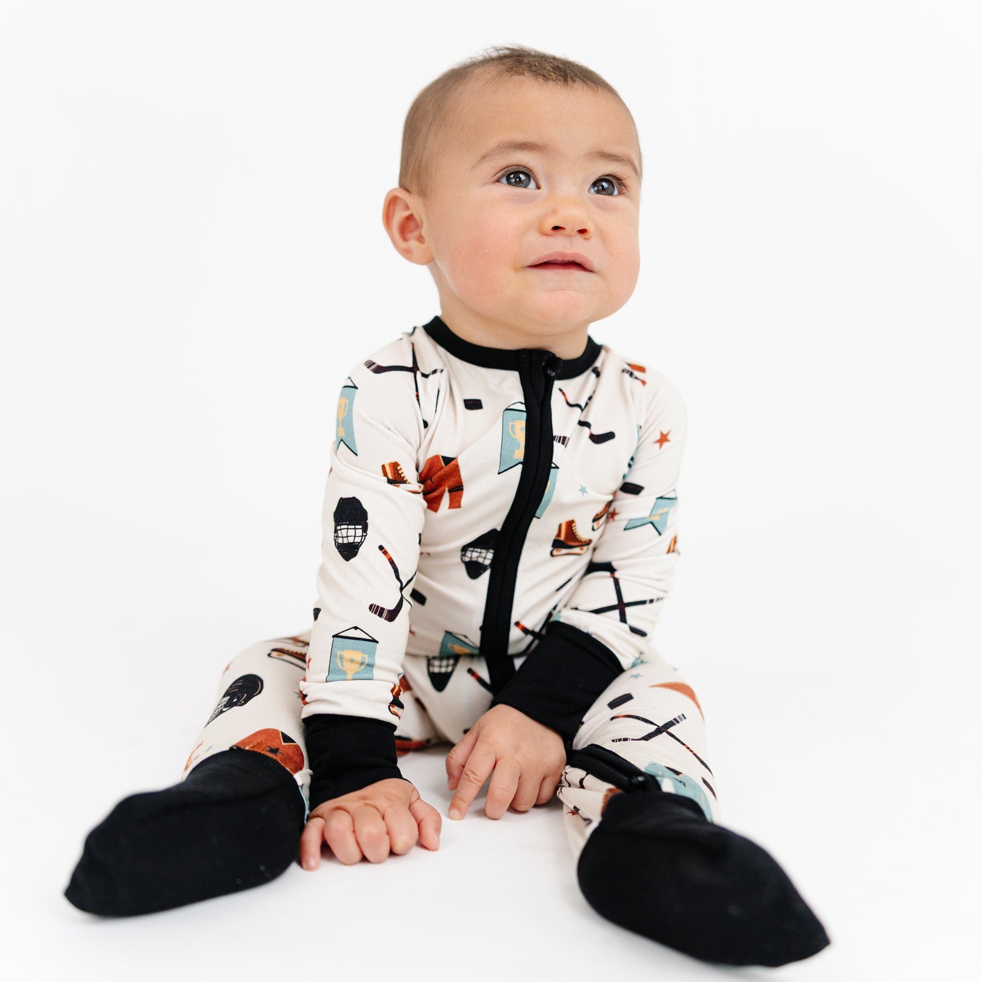 Baby wearing a patterned onesie on a white background