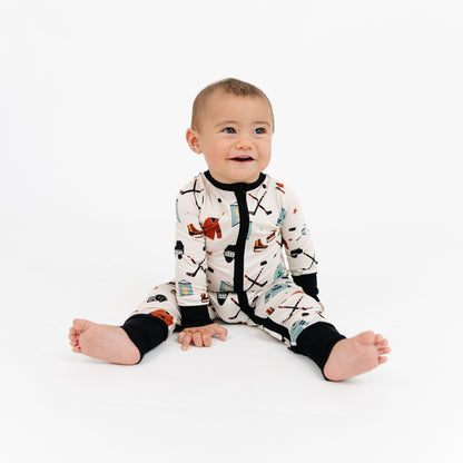 Baby wearing a patterned onesie on a white background