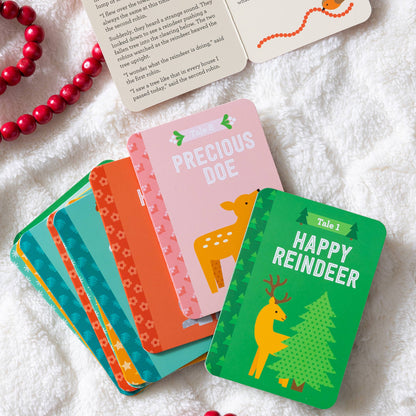 Set of colorful cards with Christmas-themed designs on a white fabric background.