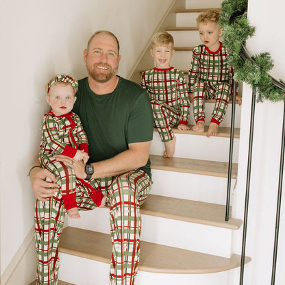 Family sitting in stairs matching in holiday plaid bamboo pajama