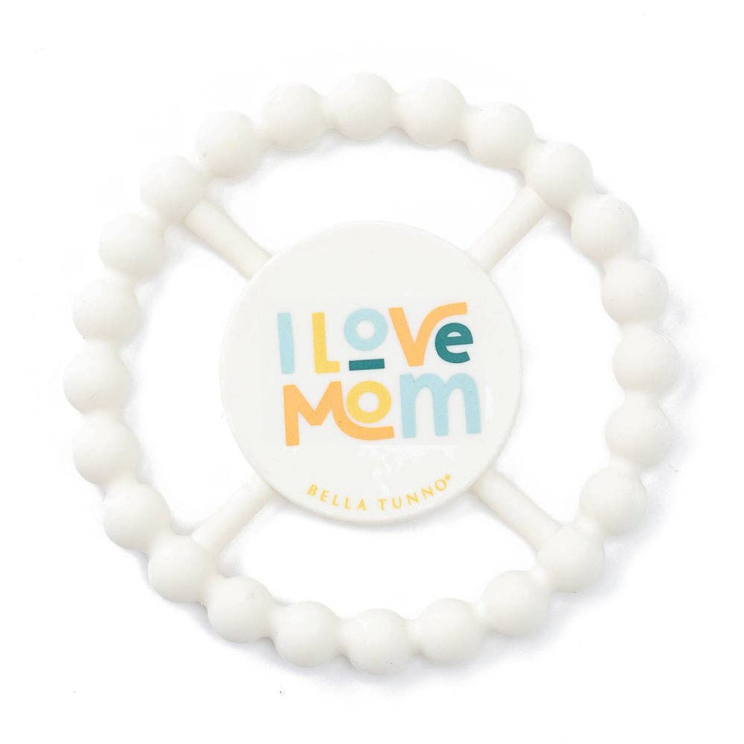 white baby teething ring that says i love mom on it