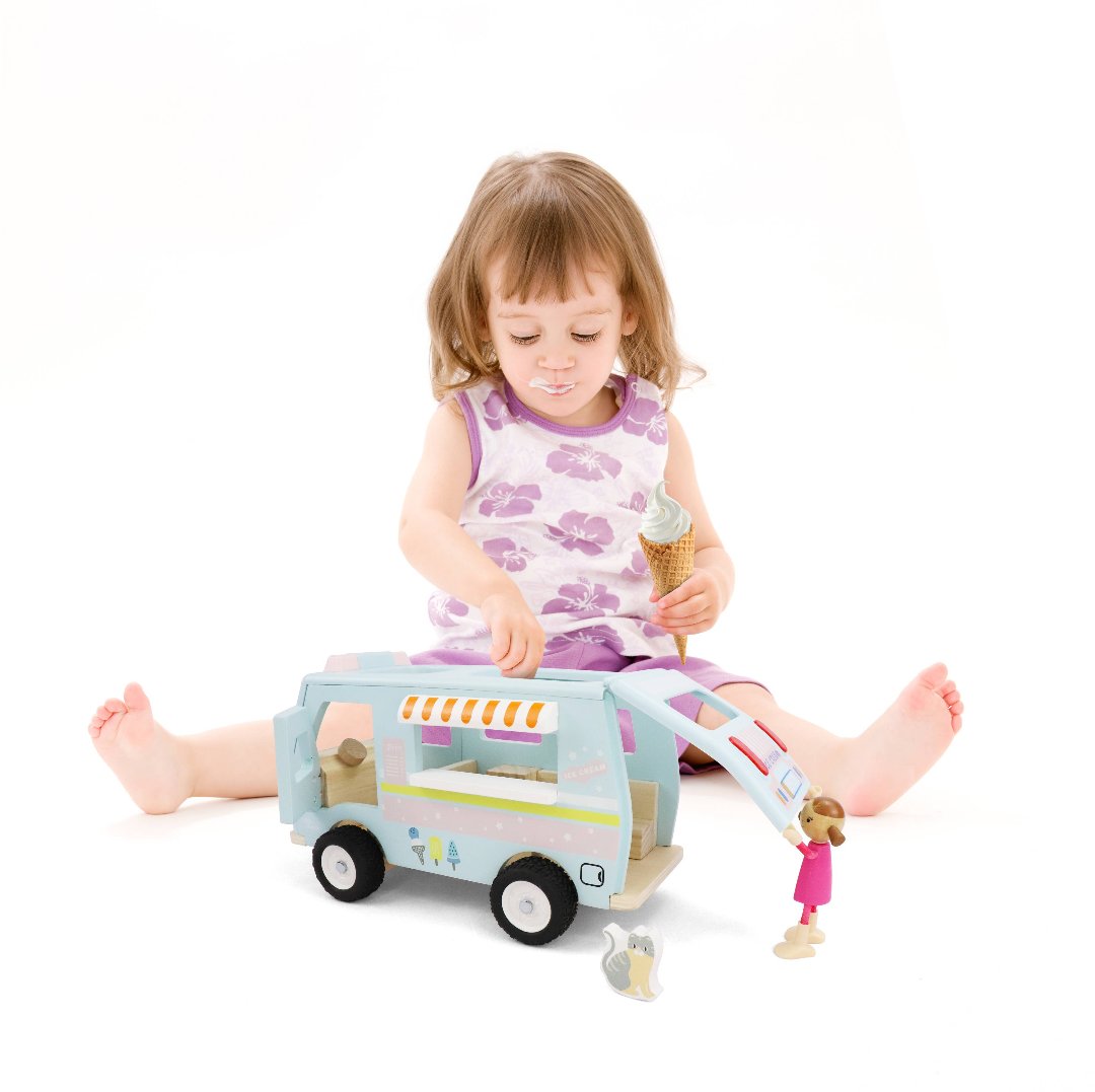 little girl playing with toy ice cream van