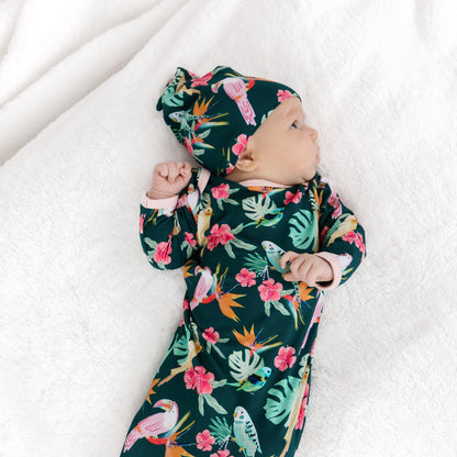 Back view of a sleeping newborn in the Isla Botánica print gown, highlighting the stretchy and soft bamboo fabric.