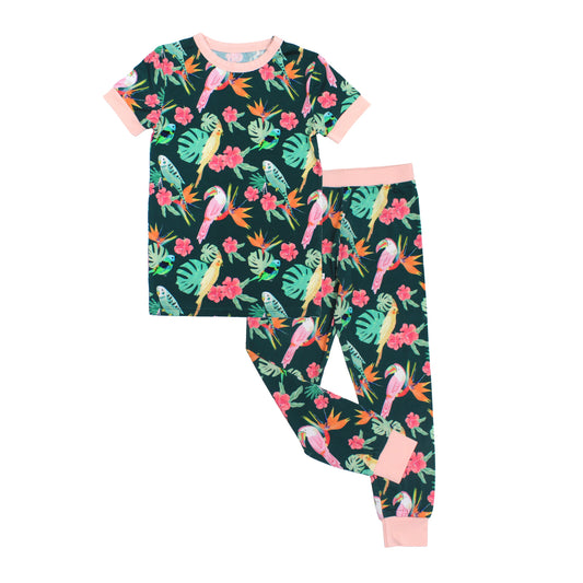 Two-piece kids bamboo pajama set with a short sleeve top and long pants in the Isla Botánica tropical birds print.