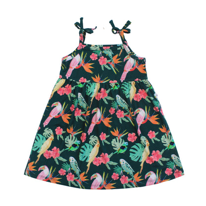Girls spaghetti strap sundress in the Isla Botánica tropical birds print with decorative shoulder bows and a flowy skirt.