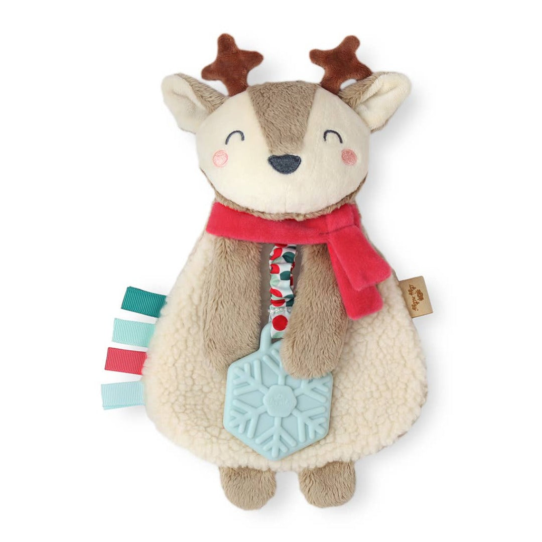 beige and brown reindeer. wears a red scarf and holds a blue snowflake. 