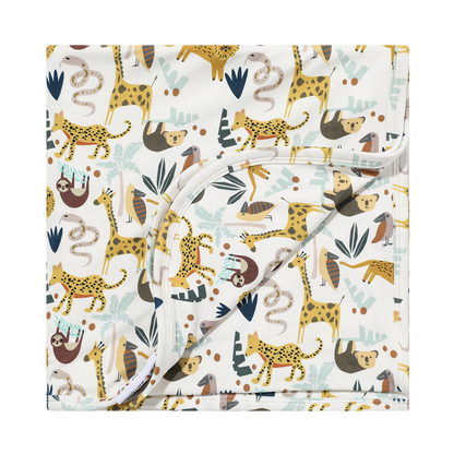 the "jungle friends" bamboo blanket. the "jungle friends" print is a mix of jungle animals that include giraffes, lions, cheetahs, sloths, snakes, and forest plants. 