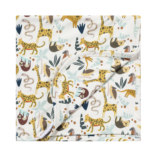 the "jungle friends" bamboo blanket. the "jungle friends" print is a mix of jungle animals that include giraffes, lions, cheetahs, sloths, snakes, and forest plants. 