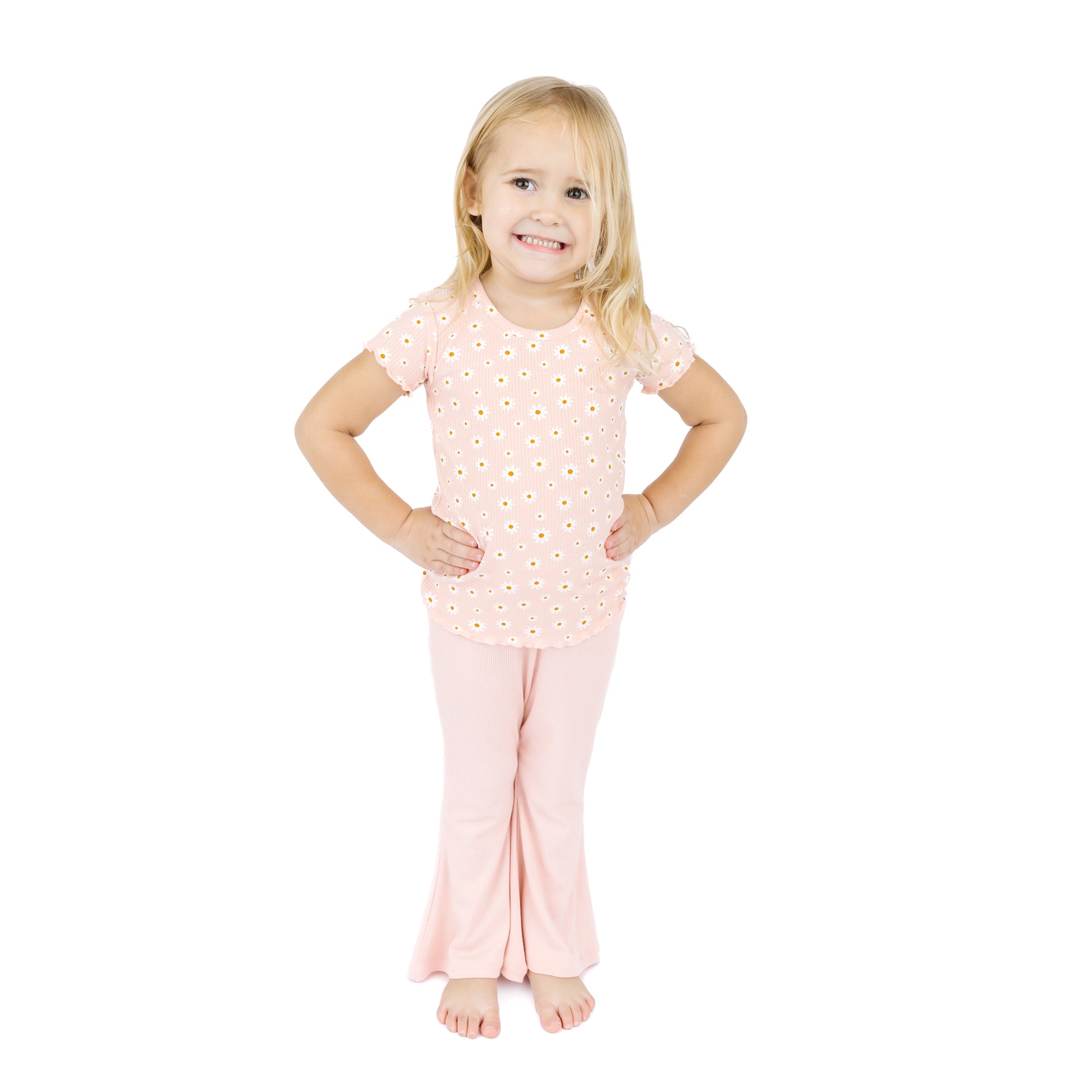 Young girl wearing a pink outfit with a white background