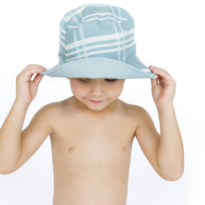 Child wearing a light blue and white striped sun hat on a white background