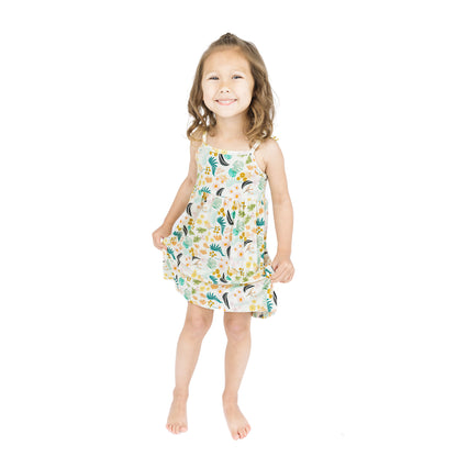 Full-length view of a child in the Tropical Blooms sundress, highlighting the lightweight, breathable fabric and twirl-worthy fit.