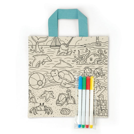 Beige canvas tote bag with a beach and animals scene and four multi-colored markers in a clear bag