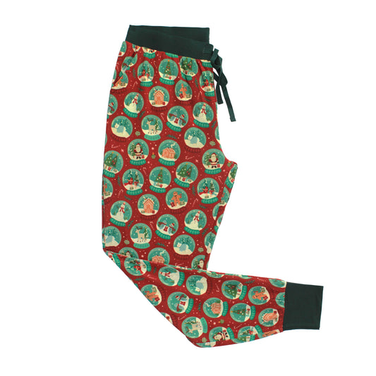 Women's Let It Snow Bamboo Pajama Jogger Pants featuring a festive red Christmas print with holiday snow globes, dark green waistband, drawstring, and ankle cuffs.