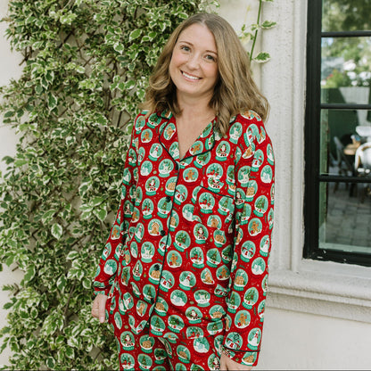 Woman smiling in Let It Snow Bamboo Long Sleeve Pajama Set featuring a festive snow globe print.