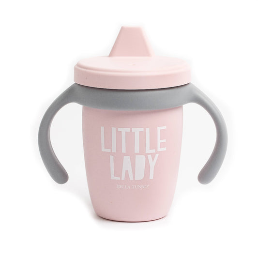 light pink sippy cup with a gray handle and it says little lady in white letters on the front