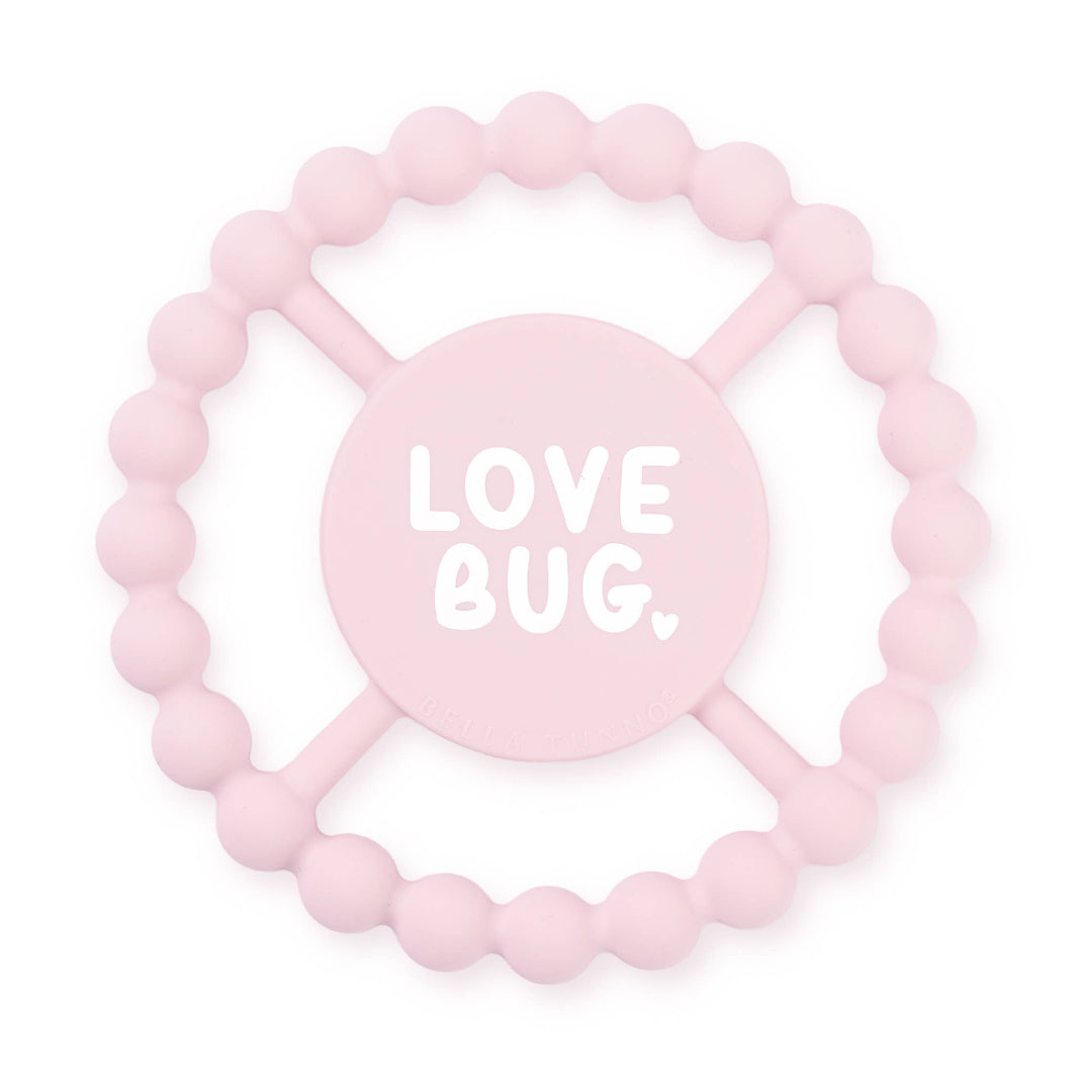 light pink round teether that says love bug in white letters