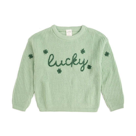 Green knitted sweater with 'lucky' and clover designs on a white background
