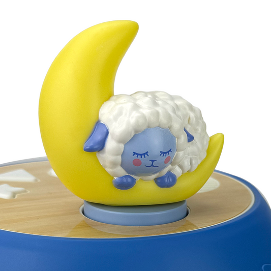 a moon shaped toy with a sleeping sheep on top of the moon. This toy is used with the Luna projector which is sold separately.
