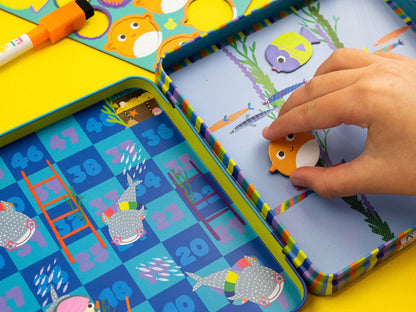 Children's educational game with magnetic fishing board and fish pieces on a colorful background