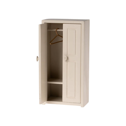 Beige wardrobe with open door on a white background