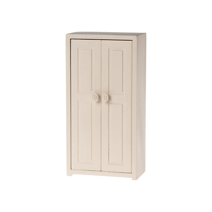 Beige two-door cabinet on a white background