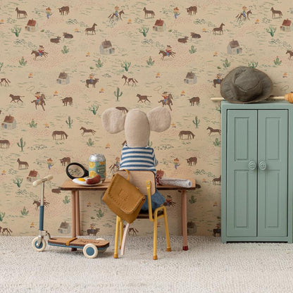 Stuffed animal sitting at a small desk with a patterned wallpaper background