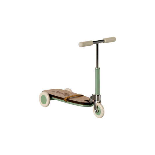 Children's scooter with a green deck and white wheels on a white background