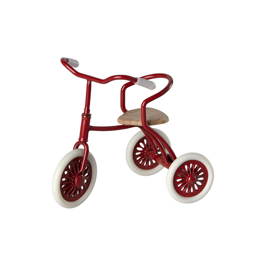 Red tricycle with white wheels on a white background