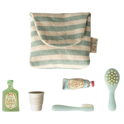 Collection of baby care products including a striped pouch, bottle, cup, and brush on a white background.