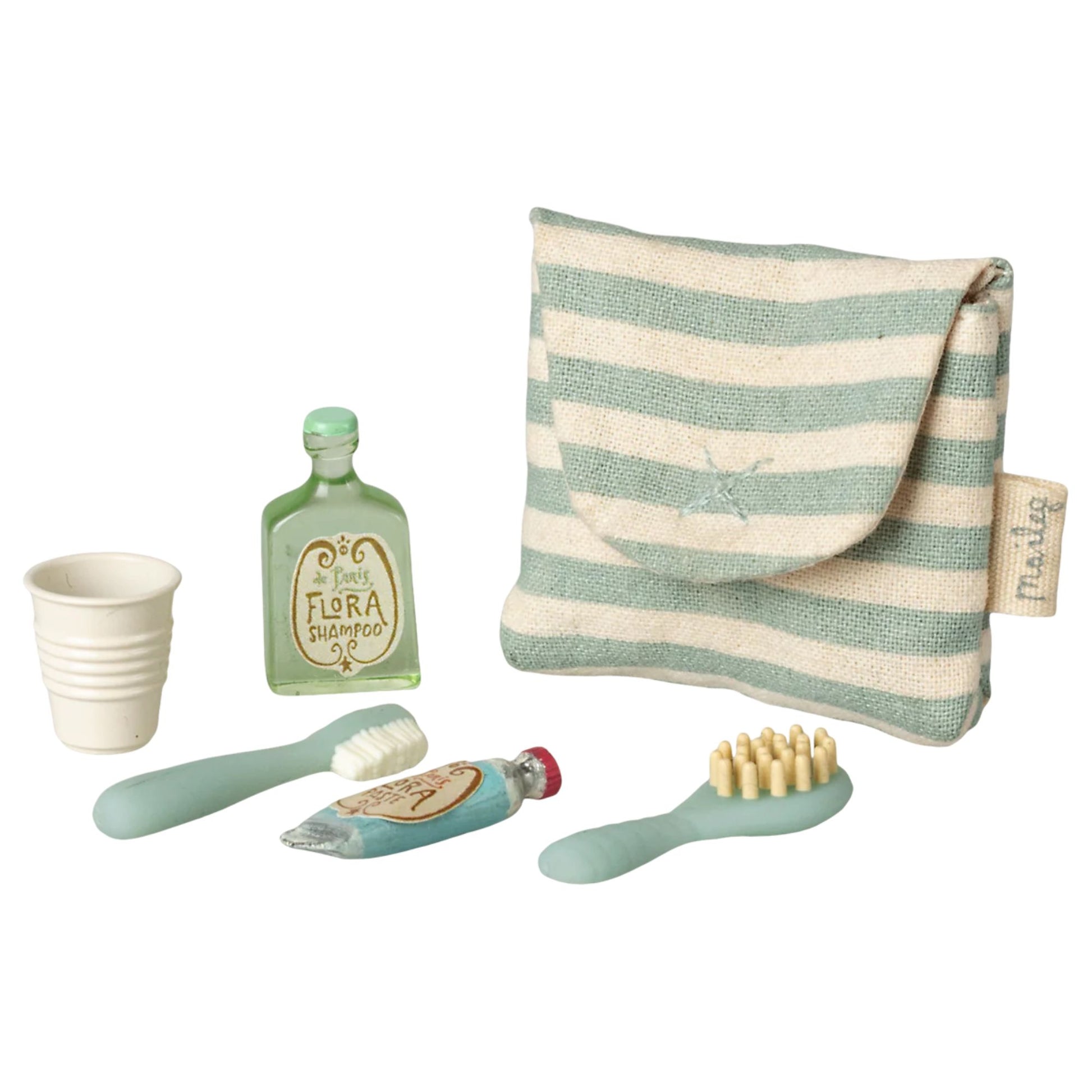 Set of children's bathroom accessories including a striped pouch, cup, bottles, and brushes on a white background.