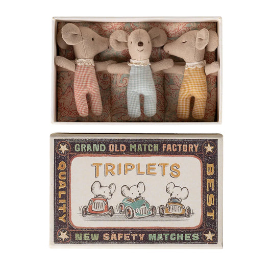 Three stuffed animal toys in a matchbox with a vintage-style label.