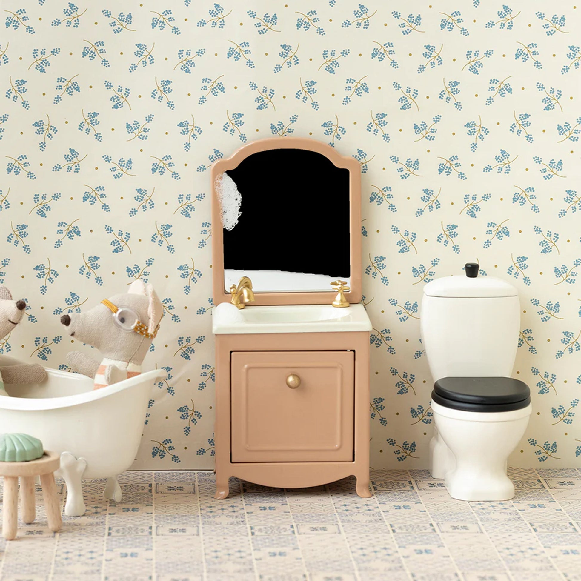 Children's bathroom with floral wallpaper, sink, and bathtub.