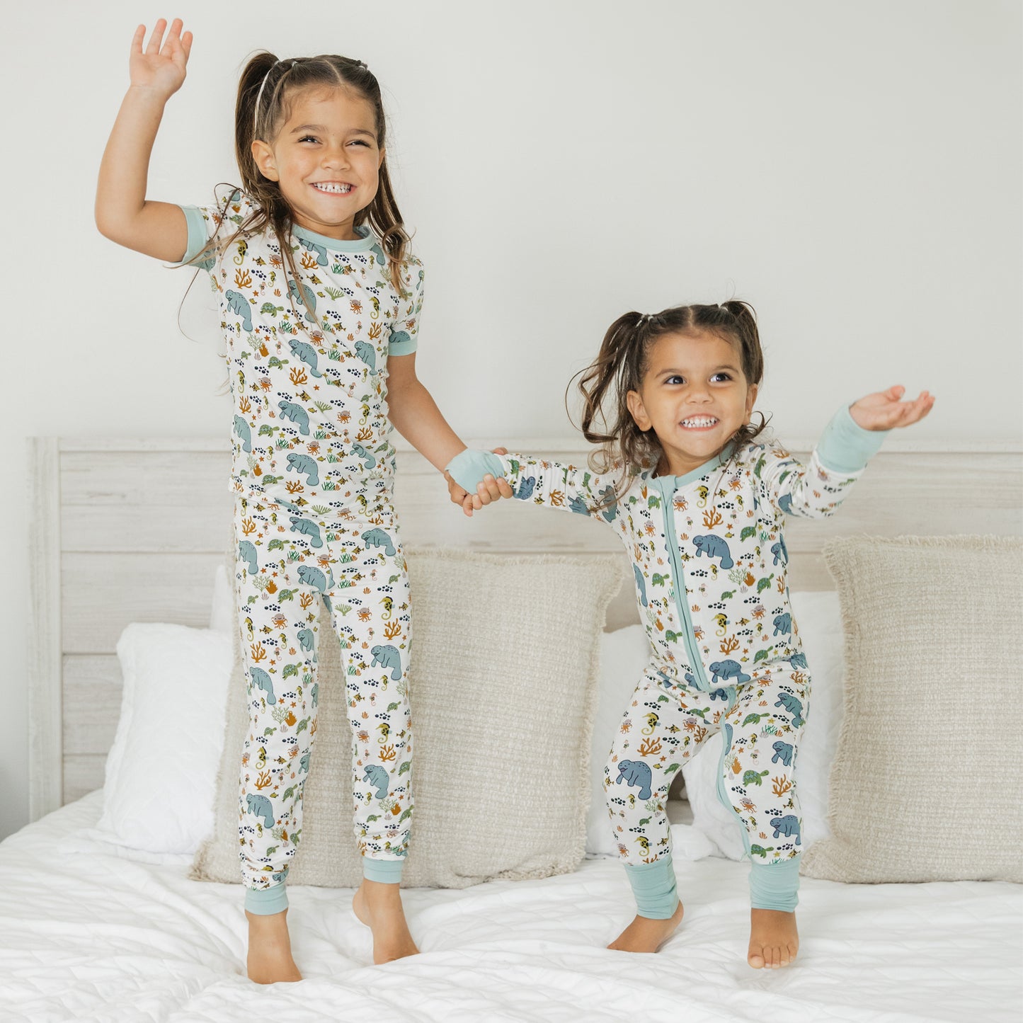 Kids wearing matching manatee bamboo pajamas standing and smiling in soft breathable sleepwear